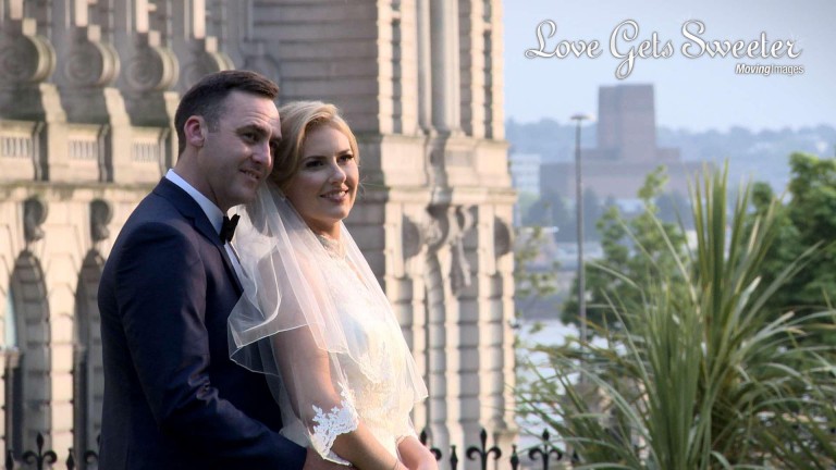 Bride and Groom posing for photographs in St Anne's Church gardens near the Liver Buildings after their wedding ceremony