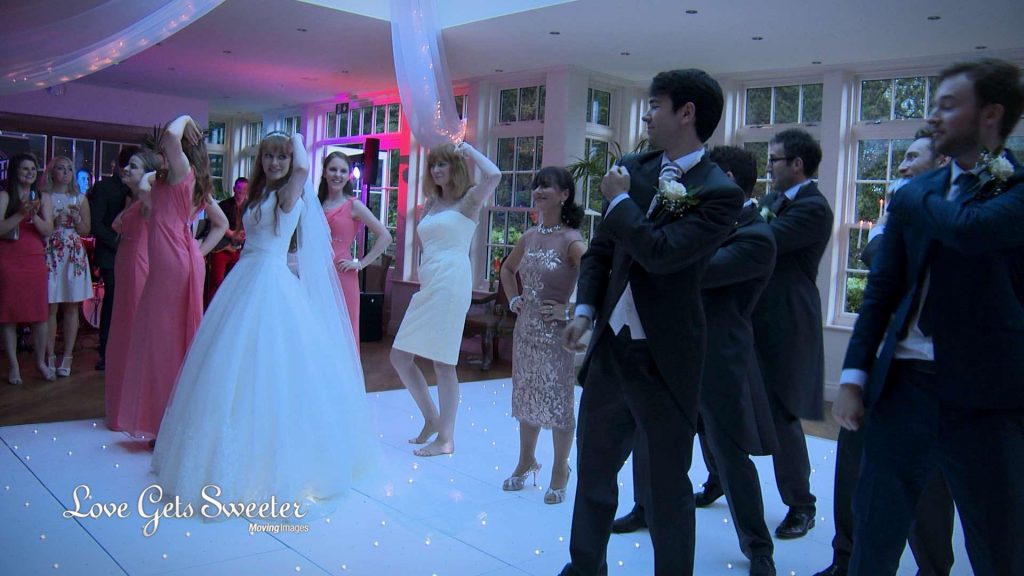 the whole wedding party perform a surprise dance to uptown funk flash mob at their Mitton Hall evening reception on the wedding video