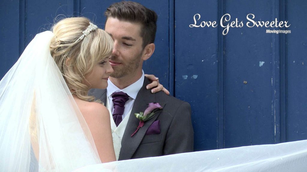 bride and groom outside a blue door for photos and video in sandbach