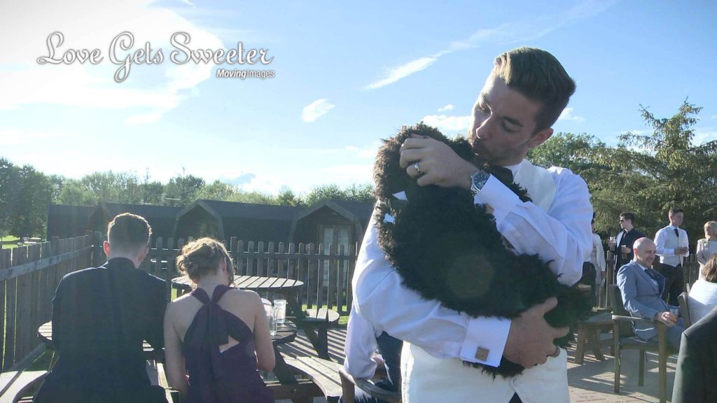 groom cuddling dog at wedding in sandbach cheshire