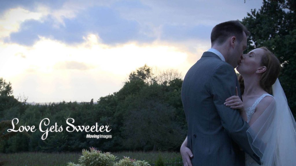romantic bride and groom shot staged for wedding video during sunset at summer wedding