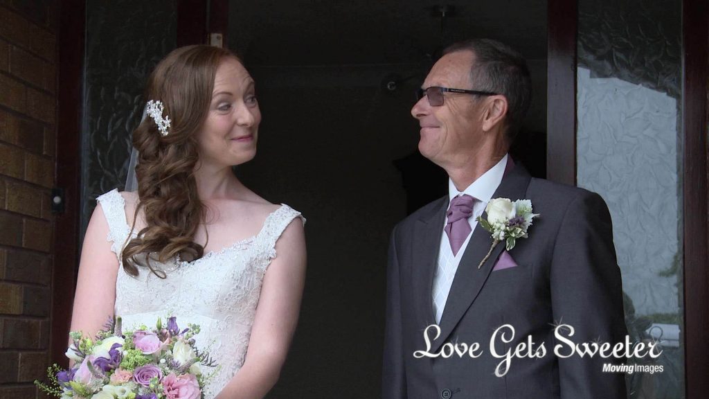 dad and daughter share a cheeky grin and smile before the wedding