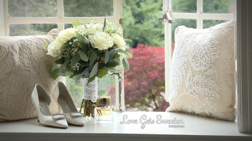 classic white bridal bouquet and shoes in Eaves Hall window