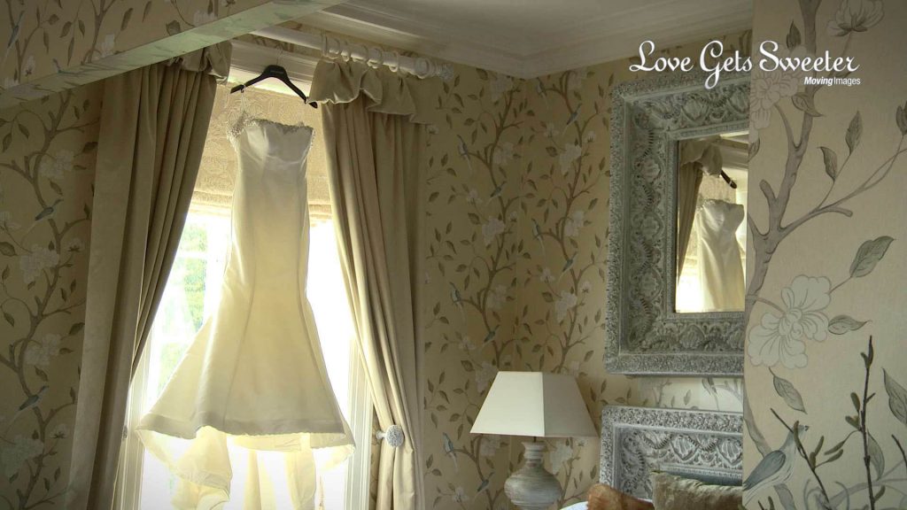 wedding dress hanging up in Eaves Hall wedding suite
