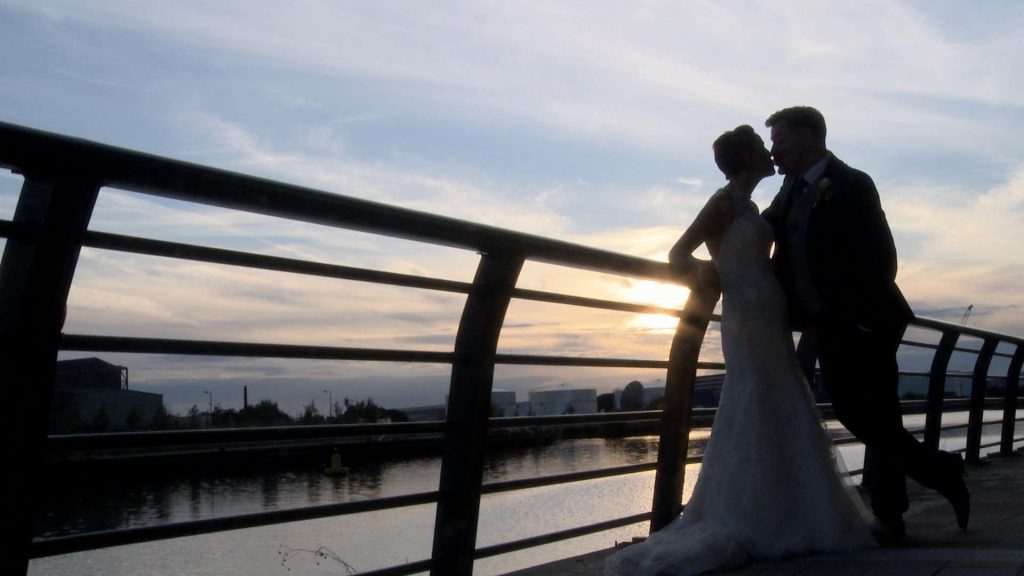 on the end of the wedding video the bride and groom have a kiss before the sun sets in Salford