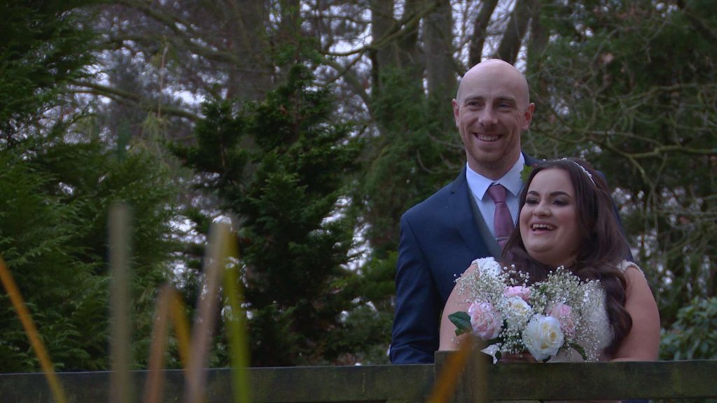 the bride and groom look relaxed as they laugh and pose in the gardens at Nunsmere hall
