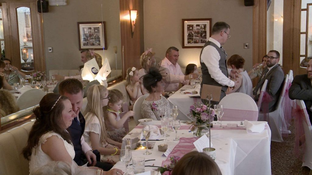 the best man has everyone laughing during his speech on the wedding video at The Wordsworth hotel in grasmere