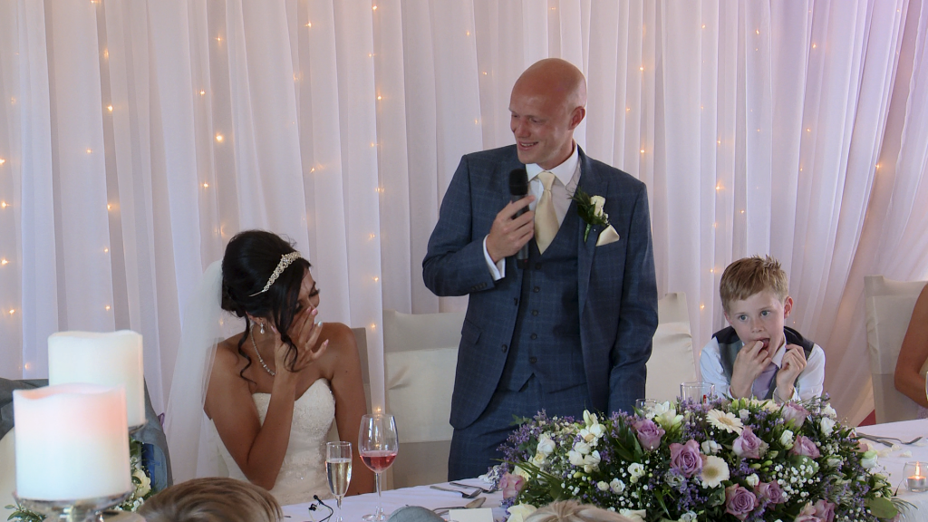the bride laughs as she wipes away her tears during the grooms speech at the blue mallard in Burscough Wharf