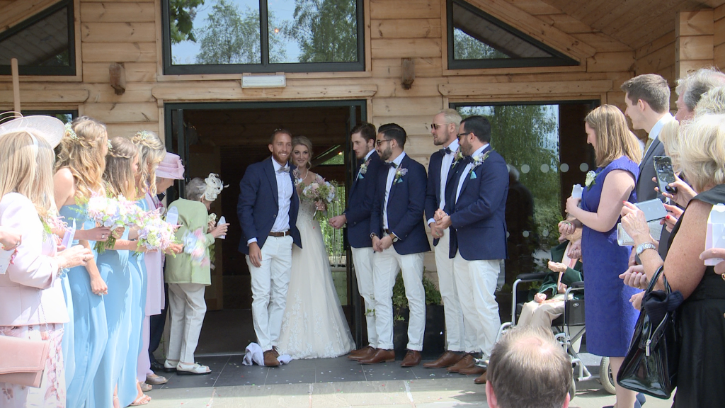 the groomsmen shout mazel tov as the groom stamps on a glass outside Styal Lodge in Cheshire