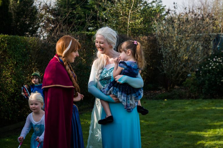 Elsa and Anna characters from Frozen dressed up from Enchanted Encounters chatting to the birthday girl in her family garden in Bursough Lancashire for her birthday party