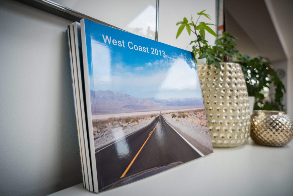 a stack of blurb family photobooks lean against a white wall in a family home in Lancashire