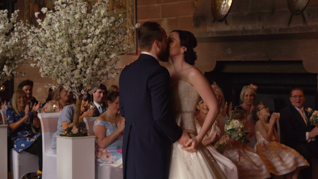 a bride and groom enjoy a kiss during their peckforton castle wedding