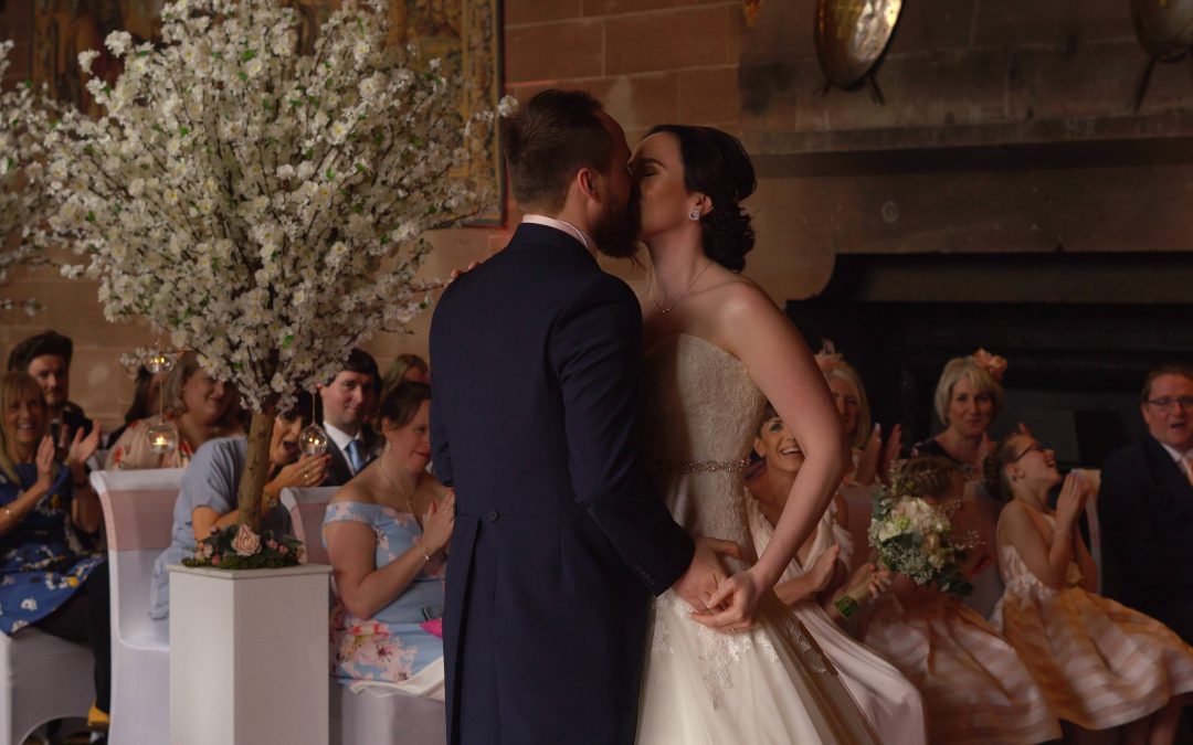 a bride and groom enjoy a kiss during their peckforton castle wedding