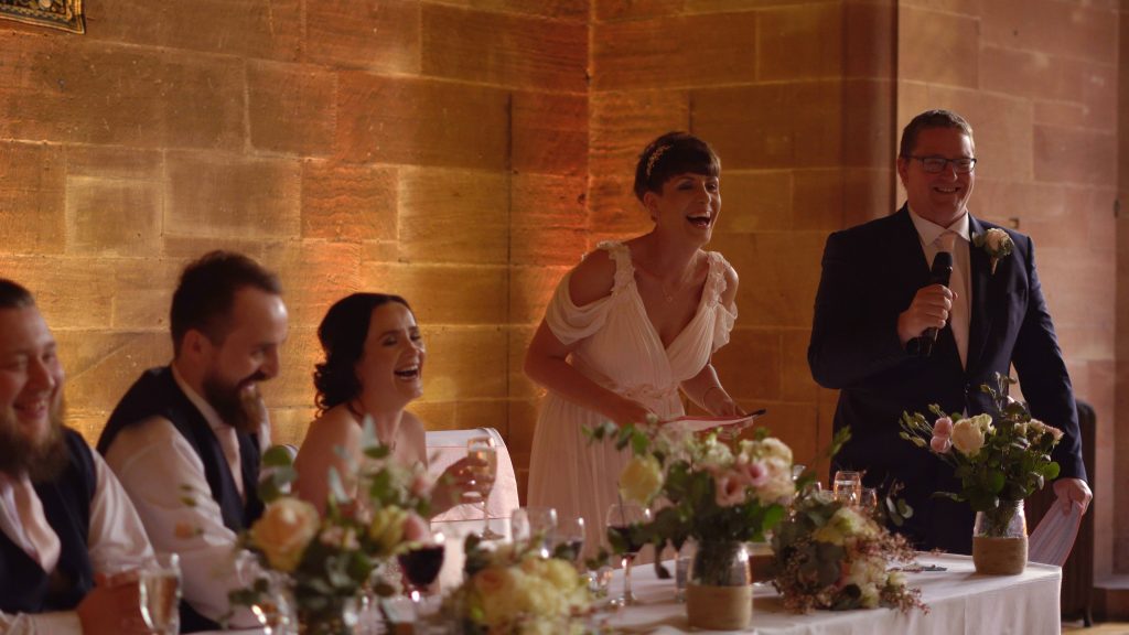 the top table laugh out loud during the wedding speeches caught on video by cheshire wedding videographer Love Gets Sweeter