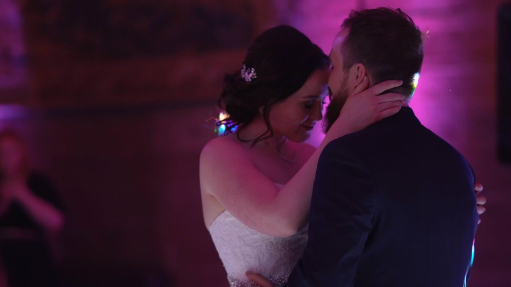 a still from the wedding video of a romantic and emotional moment during the wedding first dance in peckforton castle in cheshire