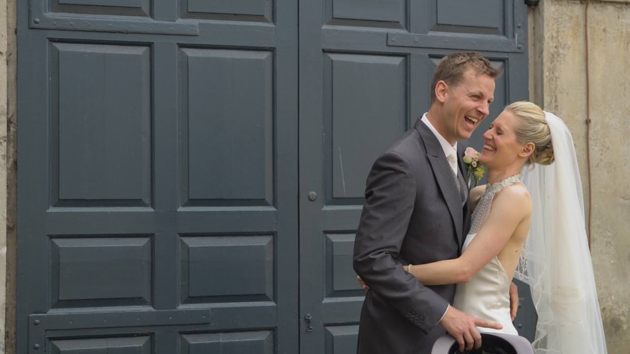 a bride and groom laugh during photos at Dunham Massey