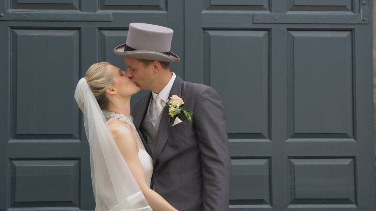 a traditional bride and groom kiss during their wedding reception at Dunham Massey