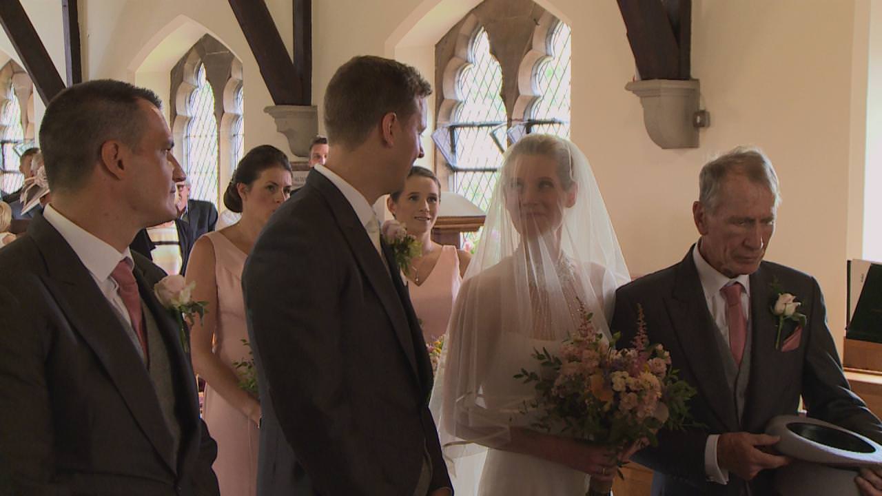 a bride looks up at her groom during a St Marks wedding ceremony in cheshire
