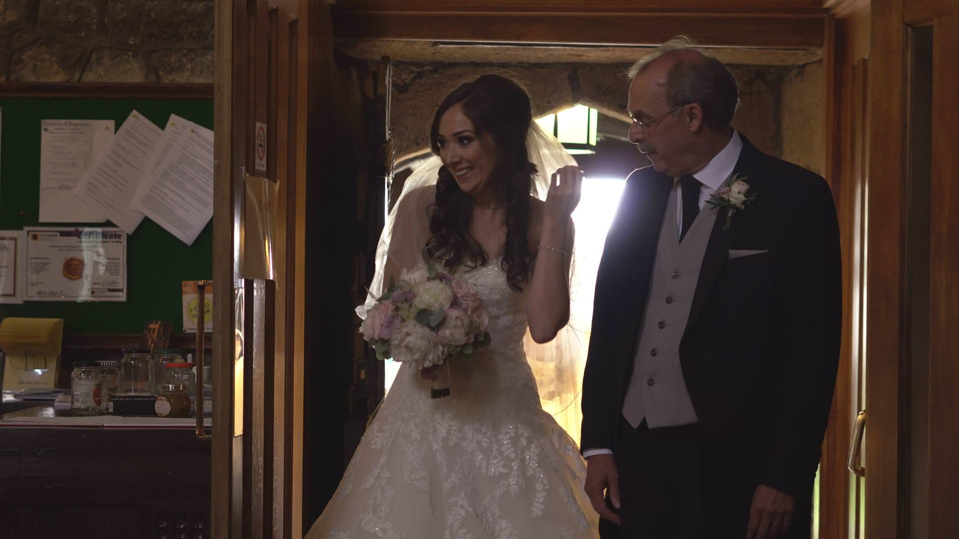 a bride smiles before she walks down the aisle at St Bartholomews and St John’s Church Great Harwood
