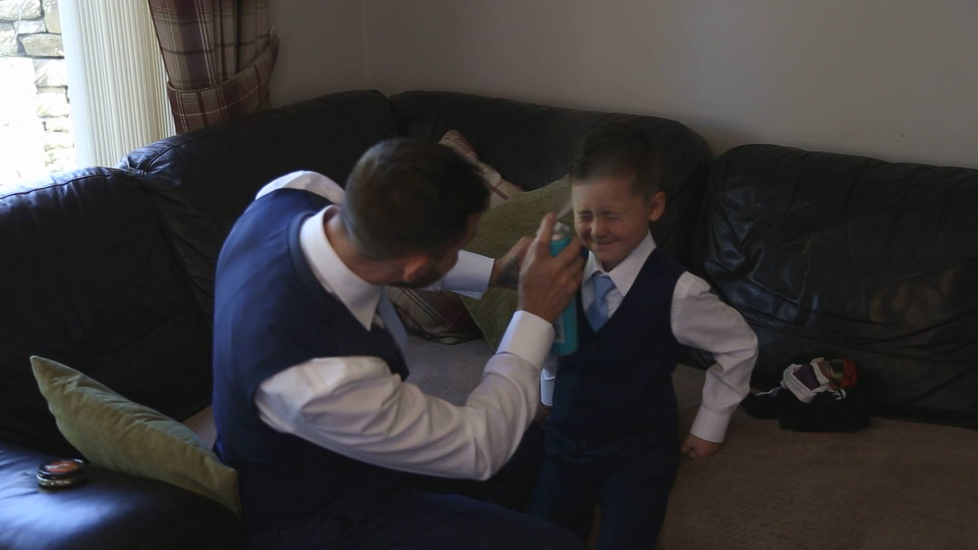 a video still of a page boy having his hair sprayed in Lancashire