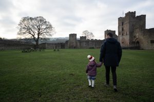 dad and daughter winter walk during family photography session in Cheshire