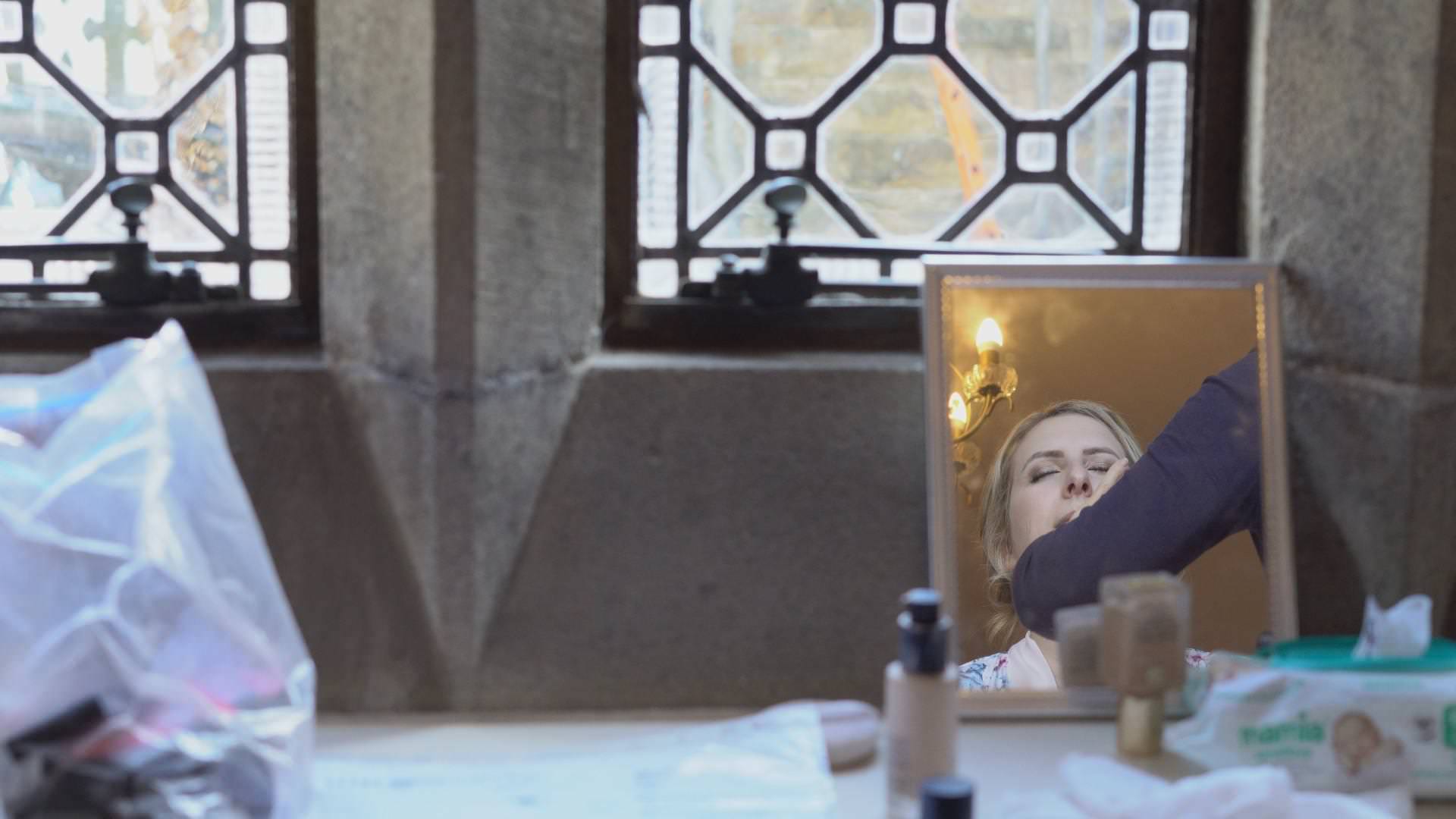 a video reflection of a bride in a make up mirror
