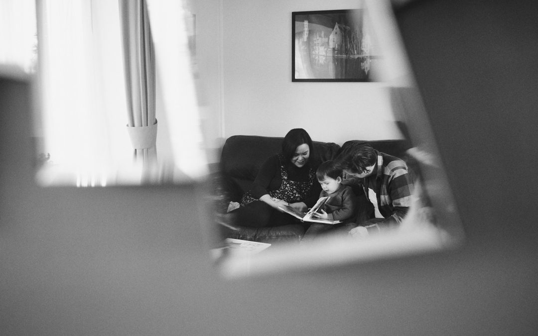 creative photo through mirror reflection of family reading at home