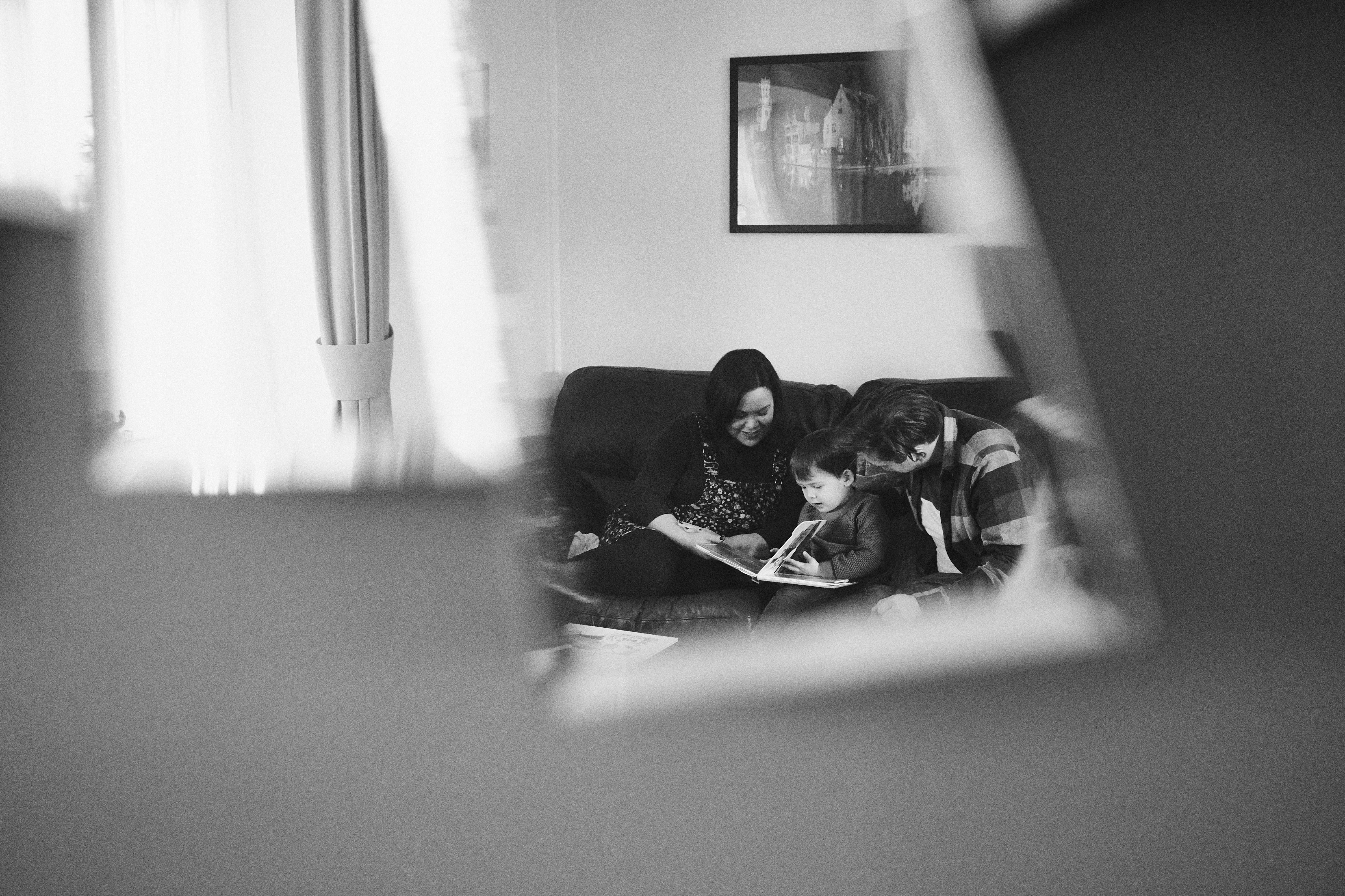 creative photo through mirror reflection of family reading at home