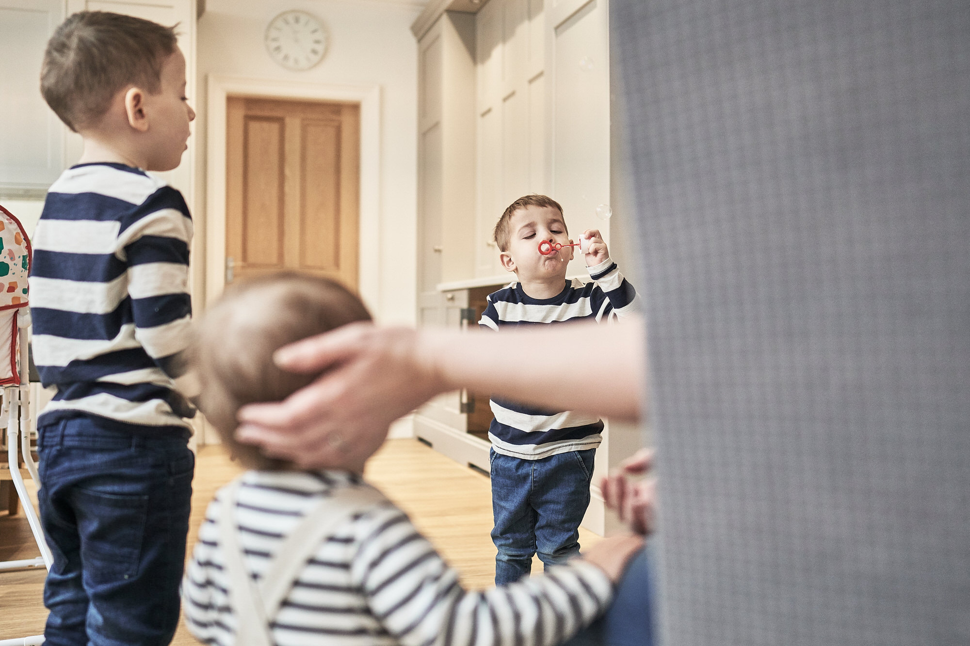 boys blow bubbles in kitchen at home
