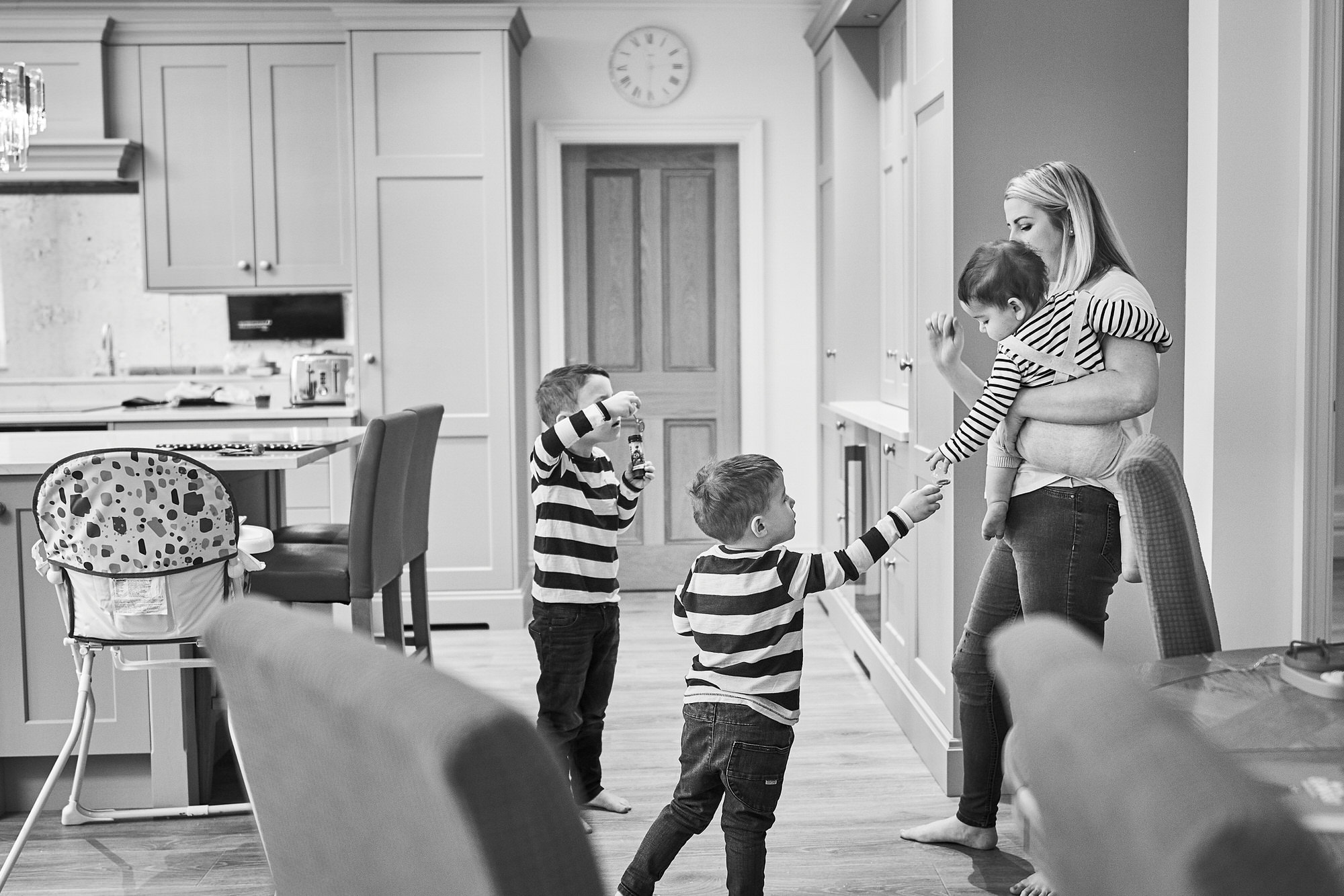 black and white photo of family in their kitchen