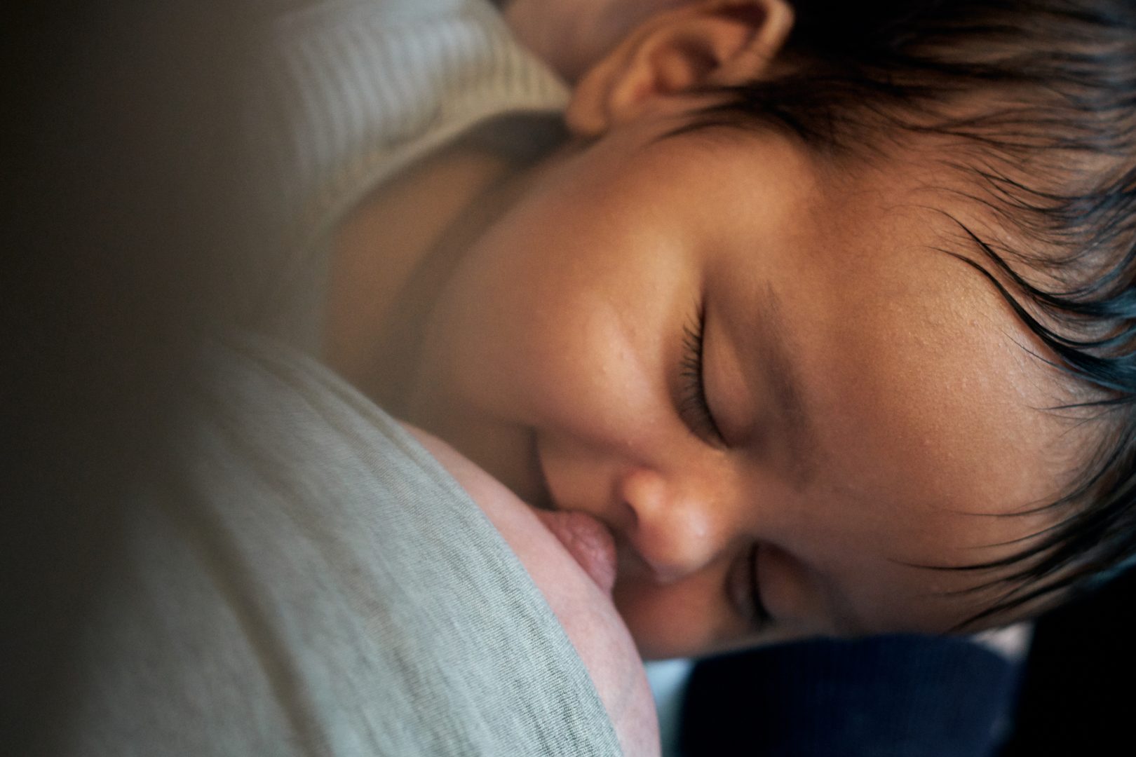natural photograph of baby smiling after a breastfeed