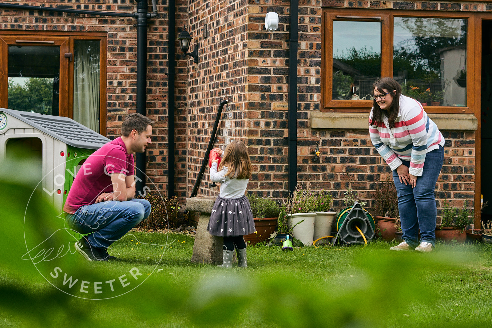 documentary photo of family playing in garden