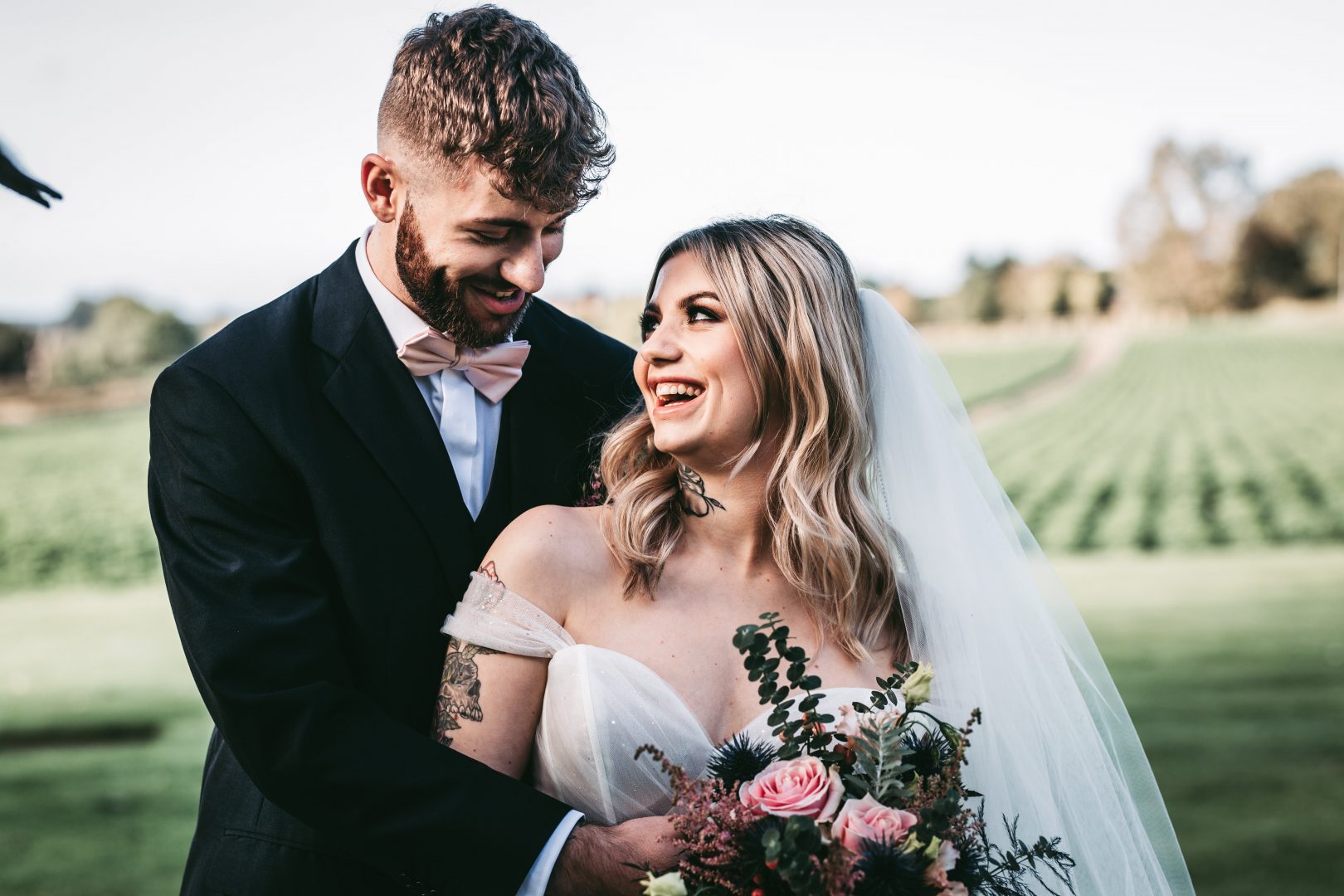 bride and groom laugh in west tower gardens