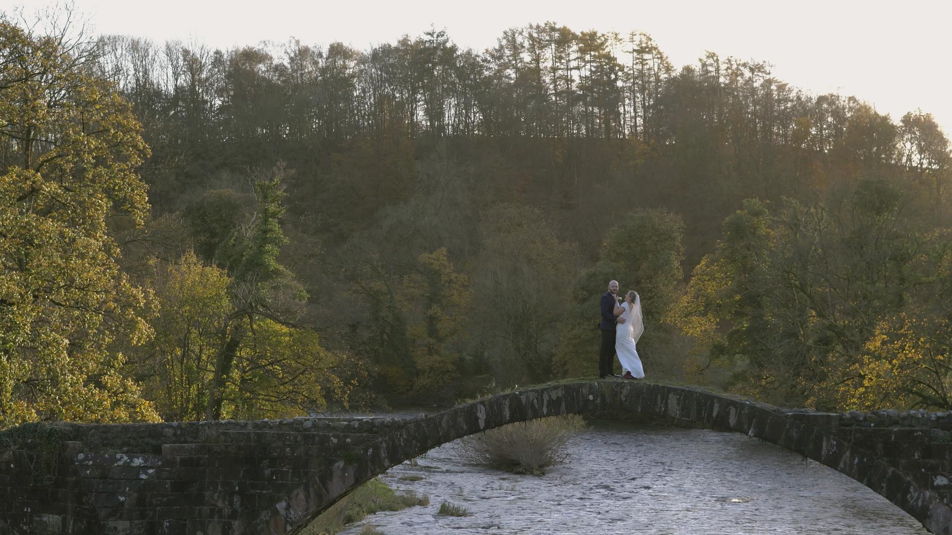 couple on cromwells bridge in lancashire for micro wedding video