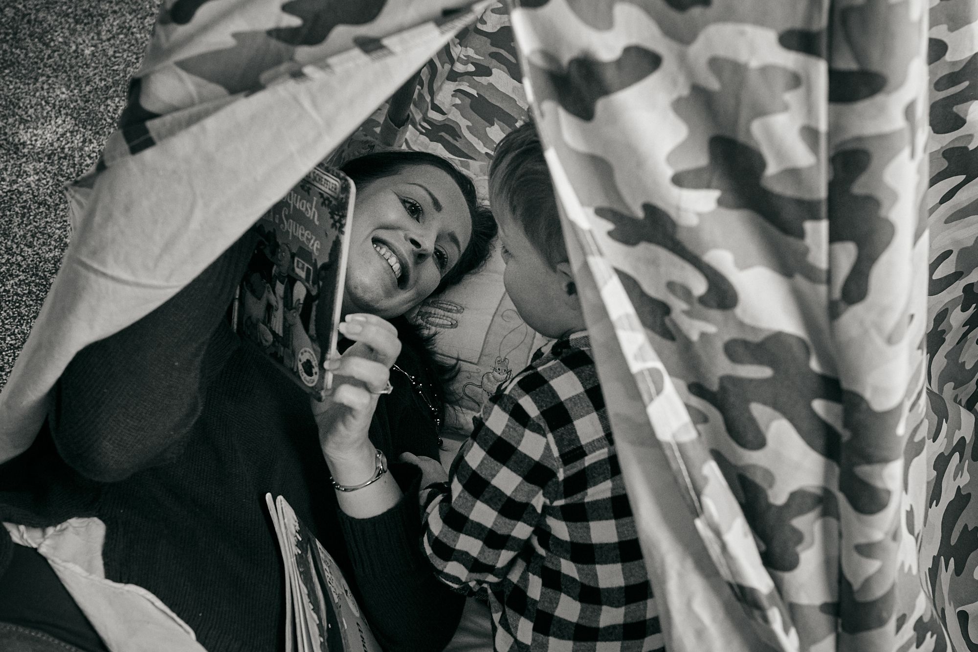 mum and child read in tipi during family photoshoot in sale