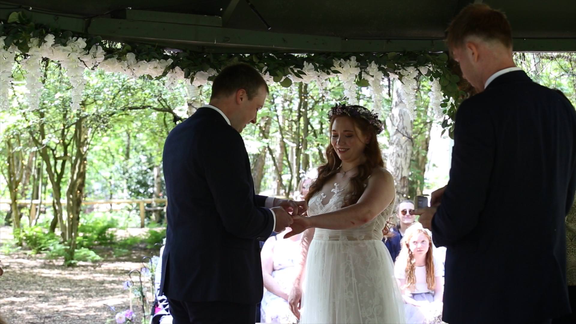 videographer captures wedding rings at outdoor cheshire woodland wedding