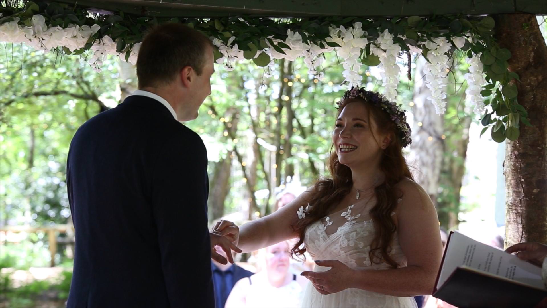 Cheshire Woodland Outdoor Wedding Video 12 bride smiles at groom during outdoor woodland ceremony in Cheshire