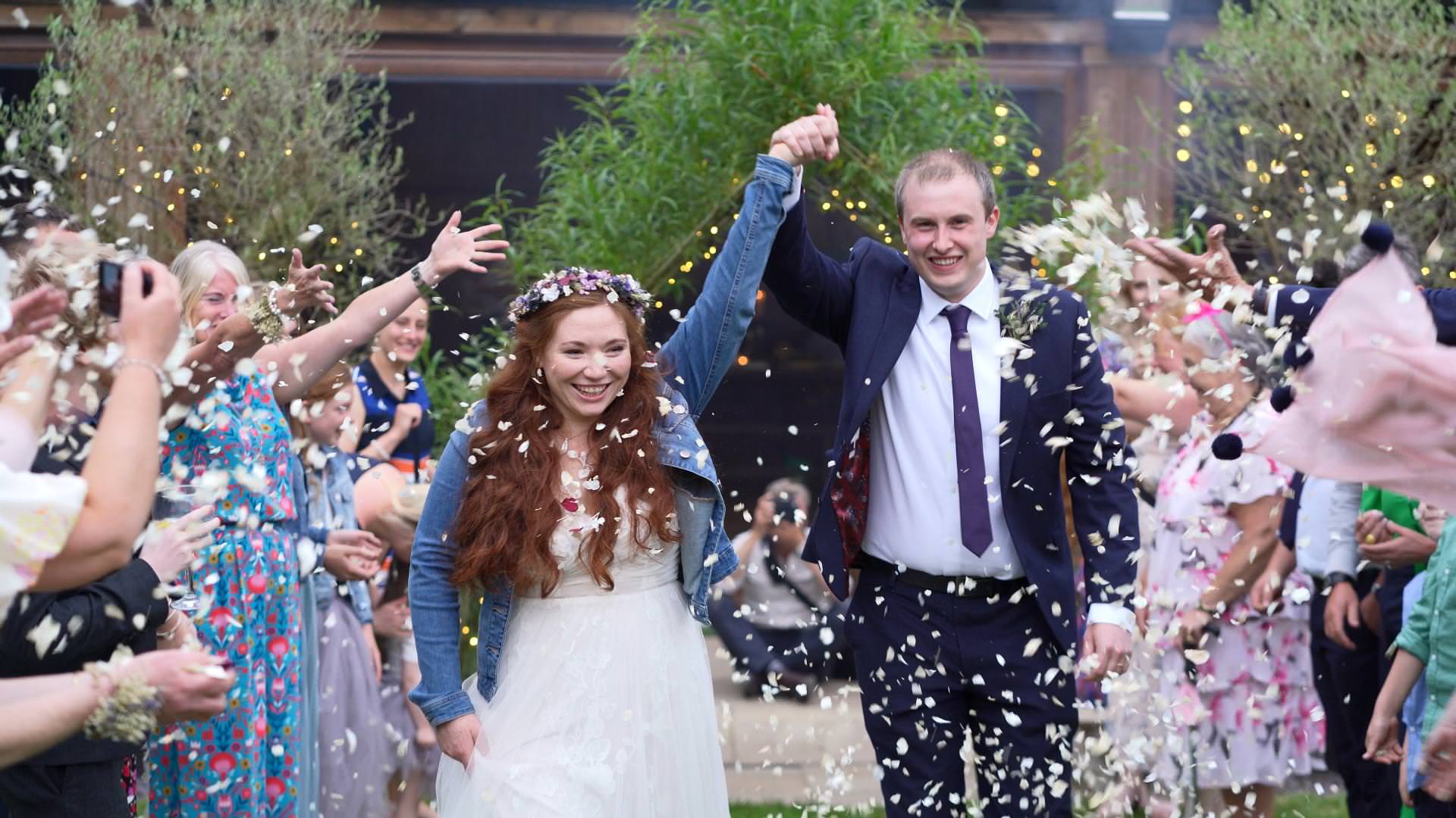 bride and groom smile during confetti cheshire woodland wedding