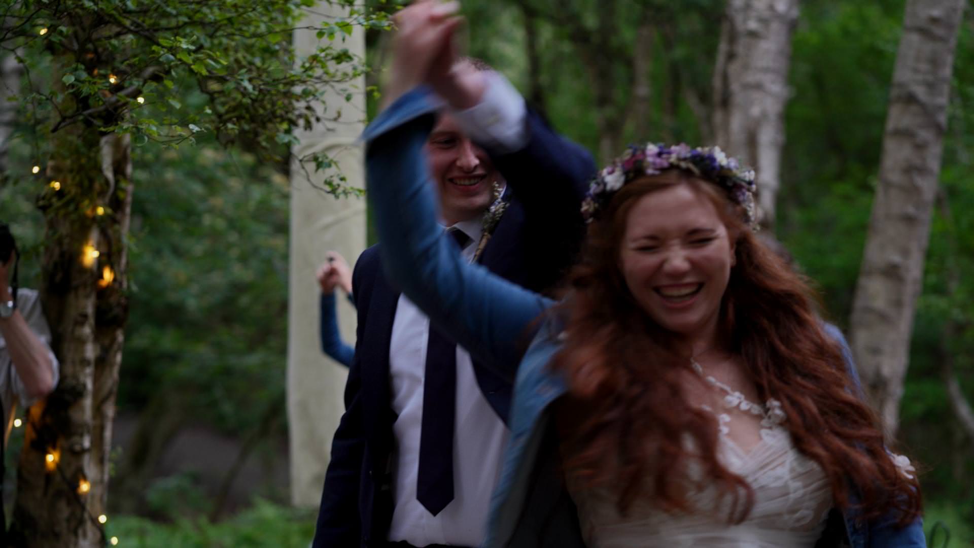 bride and groom laugh during first dance outside in Delamere Forest