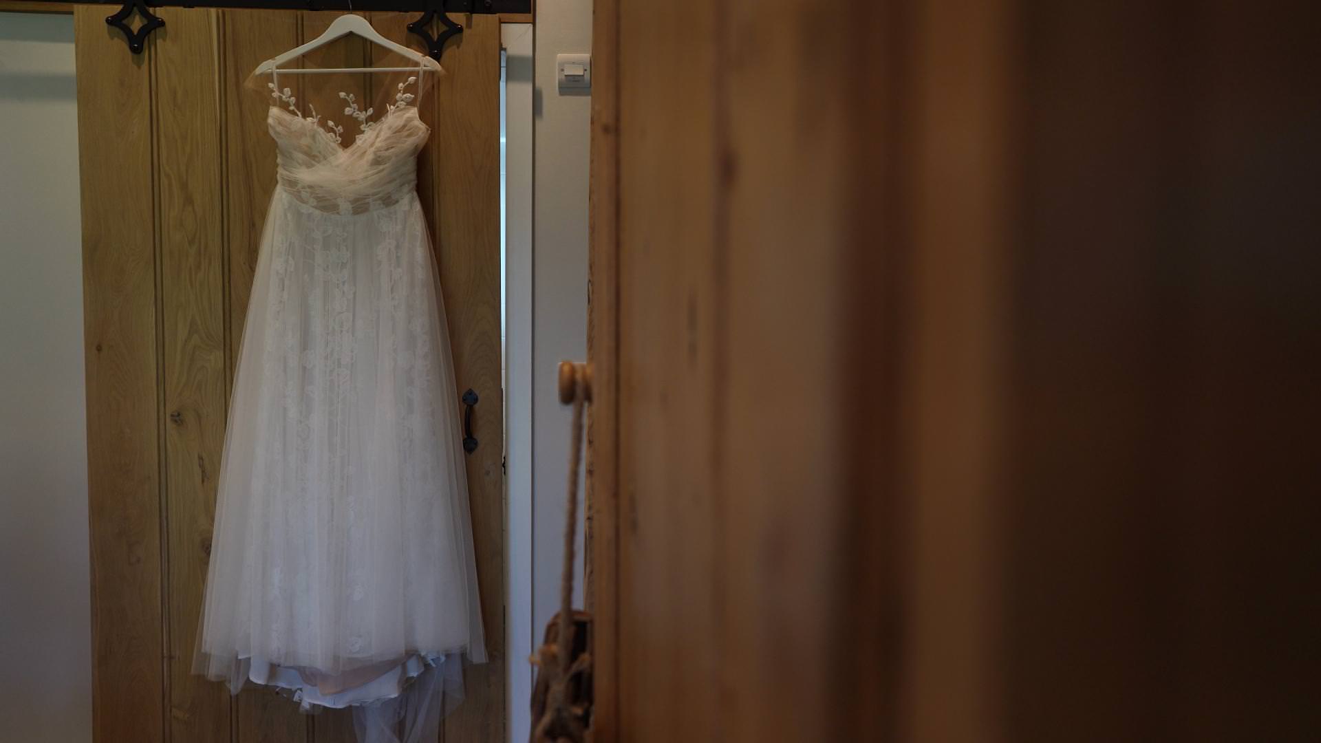 tulle wedding dress hangs ready for bride