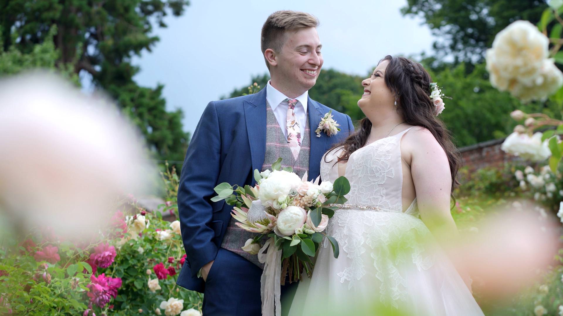natural moment of couple in rose garden in Cheshire