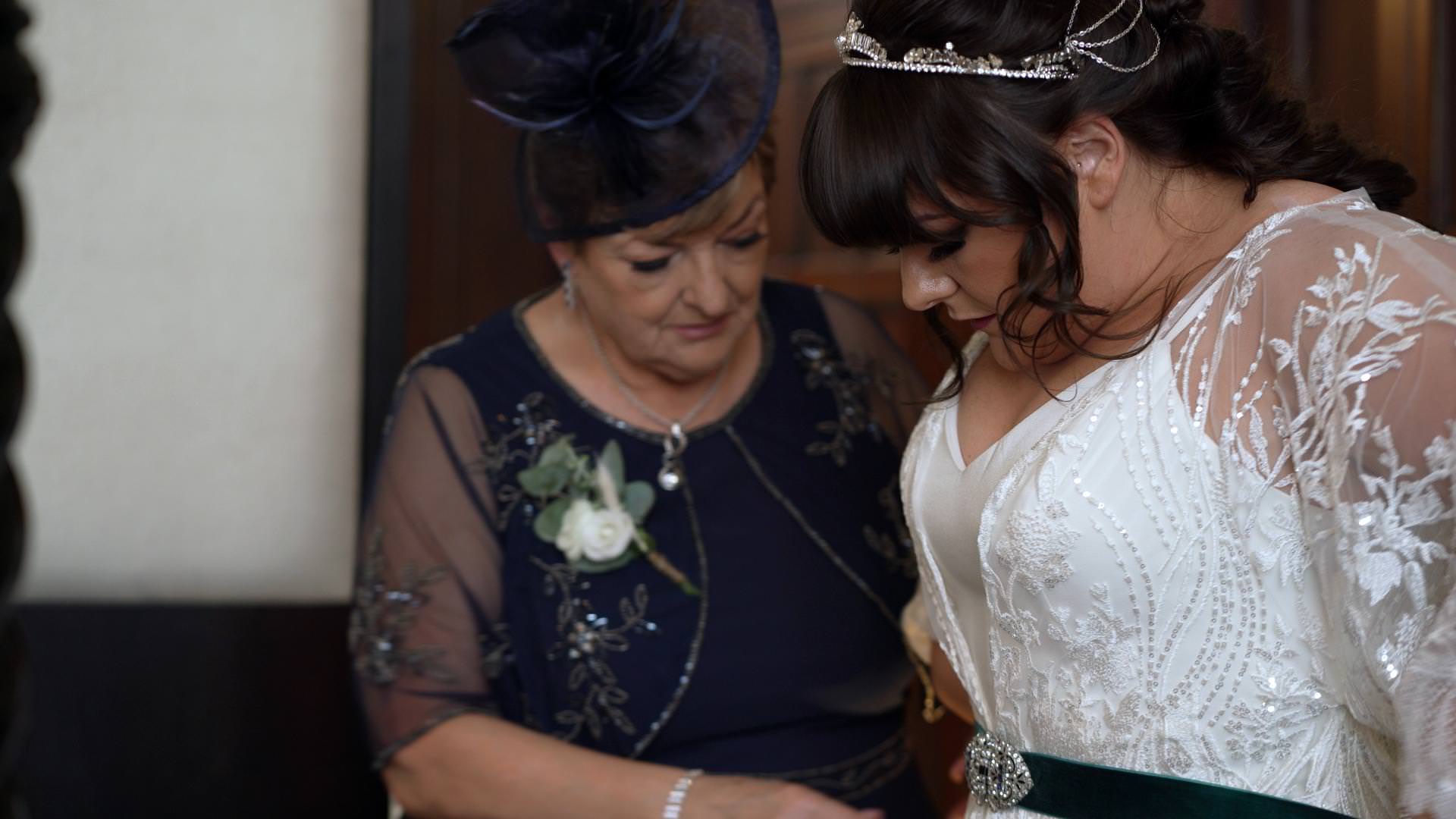 mother of the bride gets bride in her dress