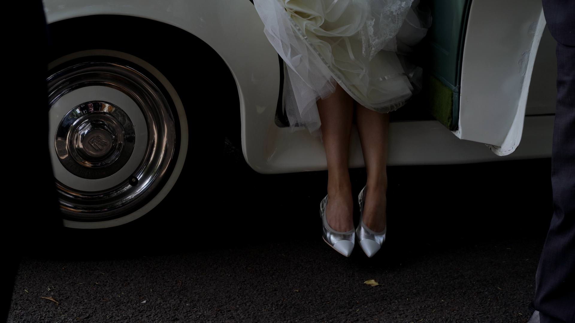 brides shoes gracefully exit wedding car outside church