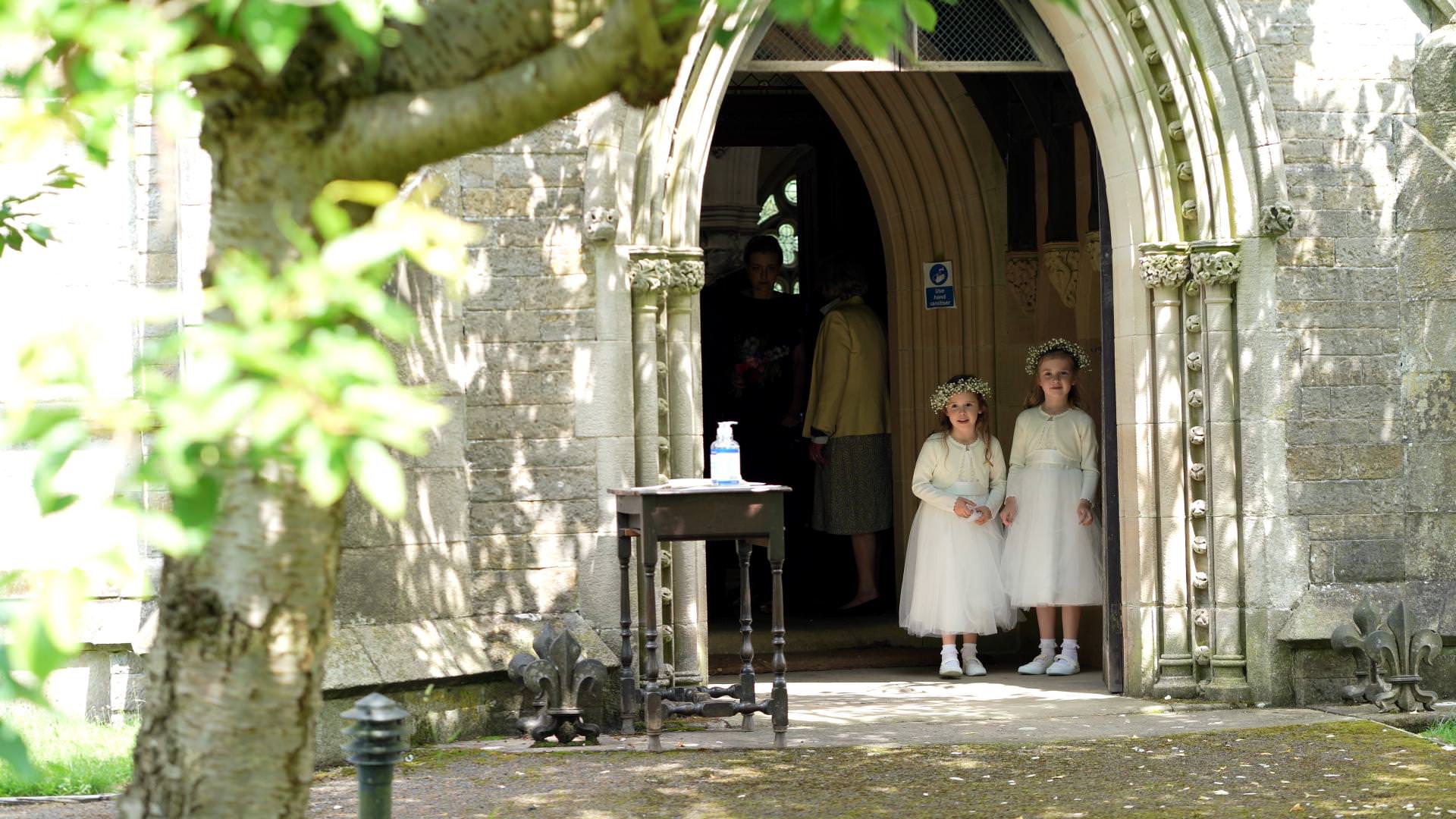 2 flowergirls wait in Osmaston church door