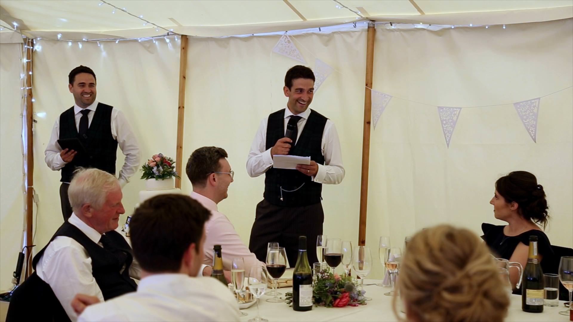 best men laugh inside tipi wedding reception