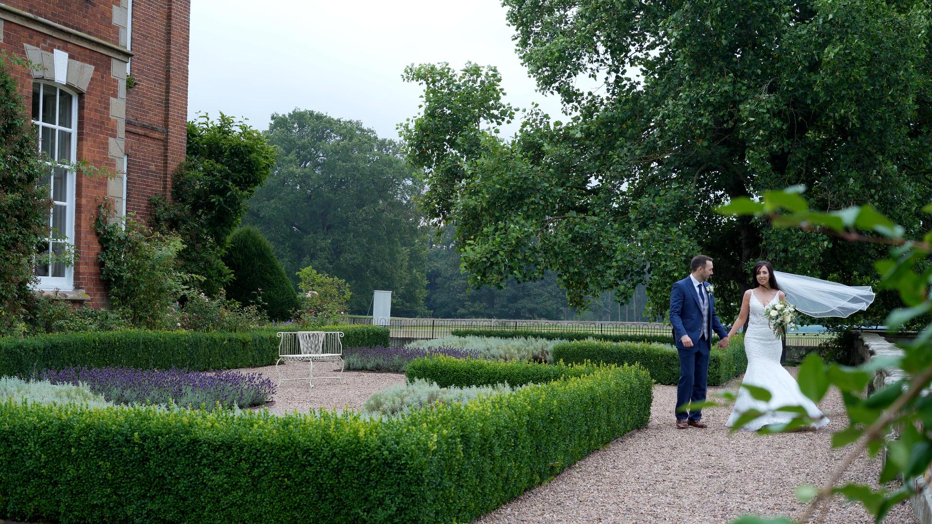 couple walk around Iscoyd Park gardens