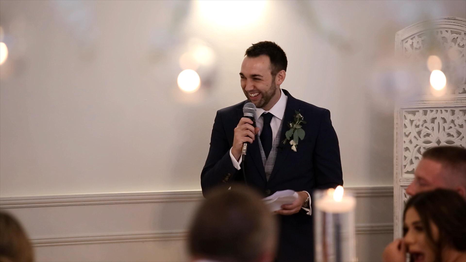 groom smiles during speech at Iscoyd