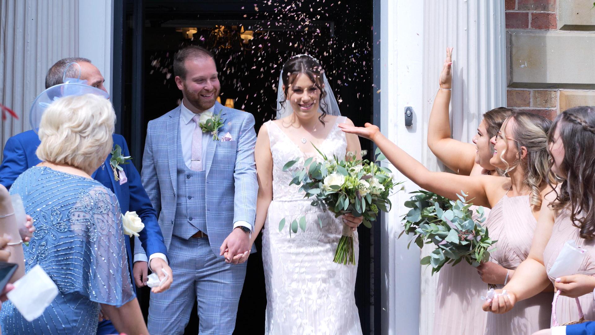 Rebecca and Nathan Ashfield House Wedding 14 videographer captures confetti outside ashfield house