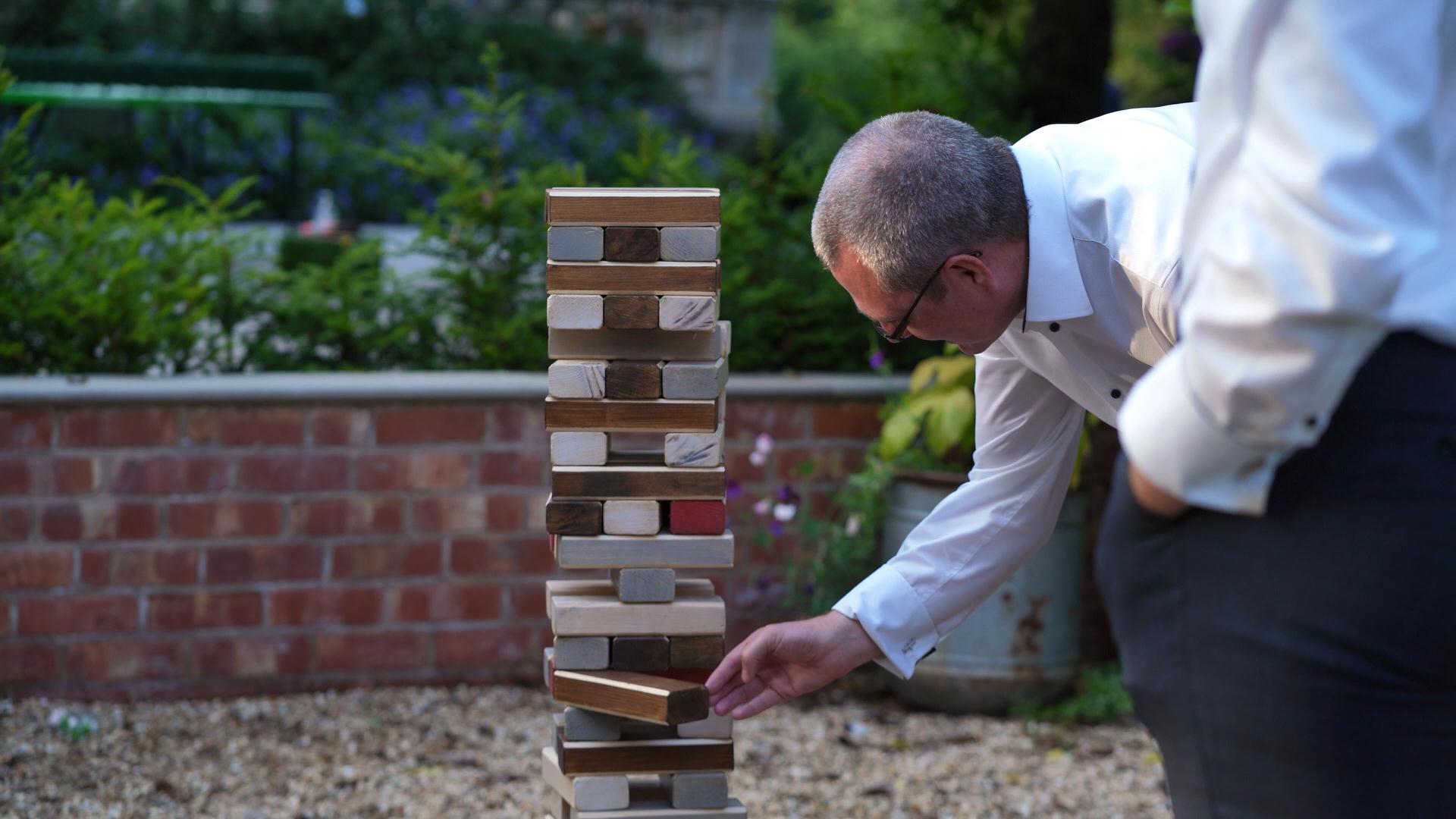 Rebecca and Nathan Ashfield House Wedding 21 close up video of wedding guest playing giant jenga