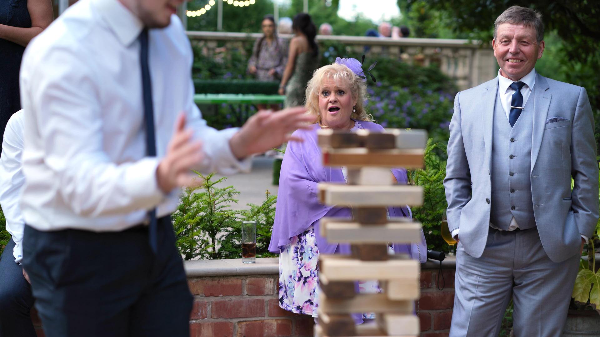 Rebecca and Nathan Ashfield House Wedding 22 guest reaction to giant jenga at wedding